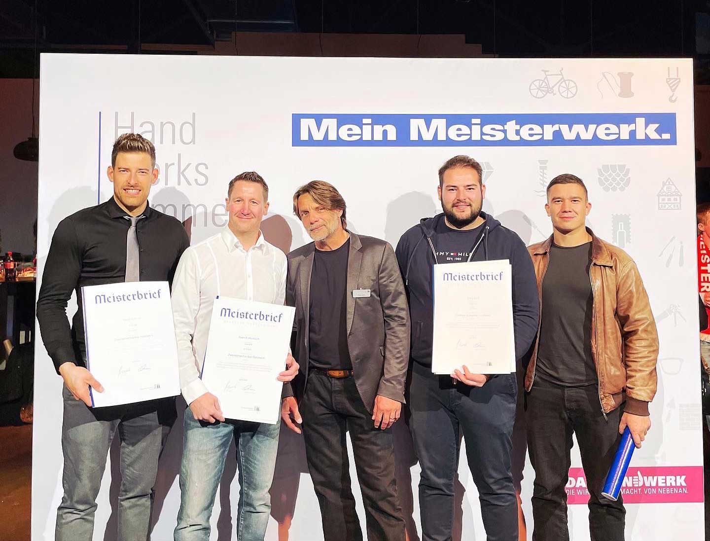 Motorradmechaniker Sven Kurtenbach mit Meisterbrief und einigen Netzwerk-Kollegen